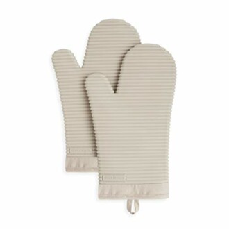 Pair of beige oven mitts with ribbed texture