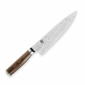 A Damascus chef knife with a wooden handle and hammered blade.