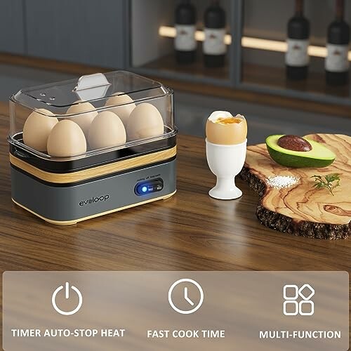 Electric egg cooker with eggs, soft-boiled egg in cup, and sliced avocado on wooden board.