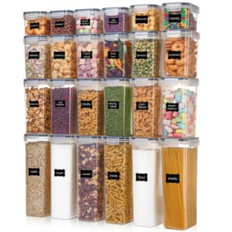 Stacked food storage containers with various snacks and ingredients.