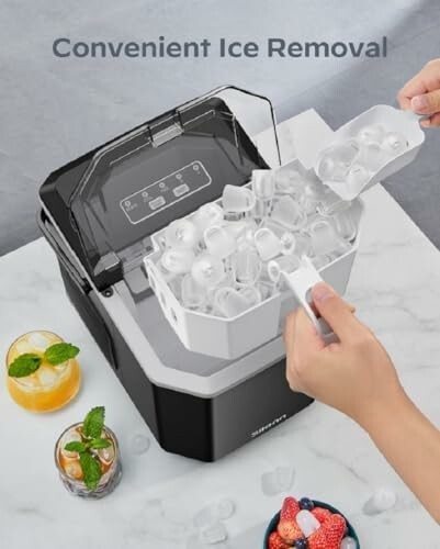 Person removing ice from a countertop ice maker