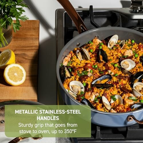 Seafood paella with mussels and peas in a pan on a stove.